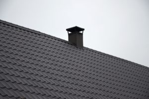 Modern brown roof made of painted metal. Corrugated metal roof and metal roofing industry concept